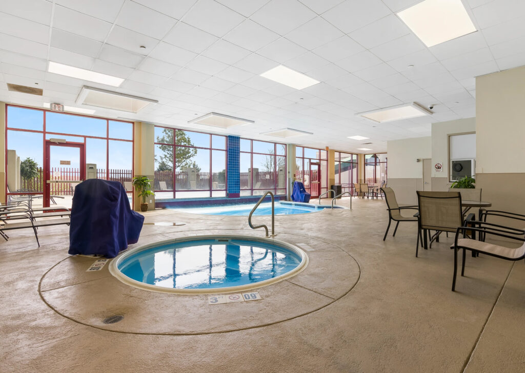 Indoor pool with hot tub and accessible seat