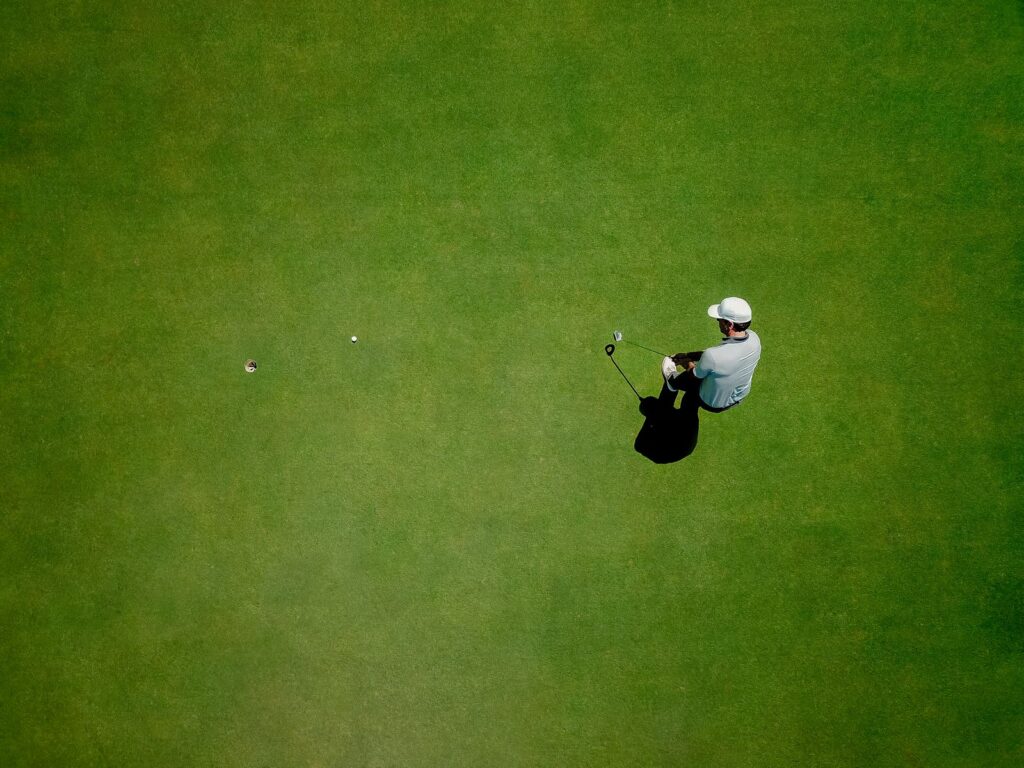 Golfer putting on the bentgrass green at Thousand Hills Golf Course in Branson, Missouri