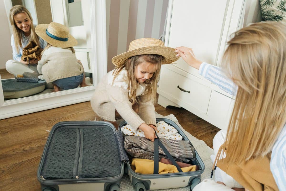 Mother and daughter packing a suitcase at home for a family vacation to Branson