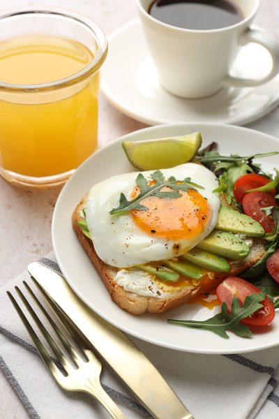 Breakfast plate with fried egg, avocado toast, and coffee from the Famous Breakfast Buffet at Thousand Hills Resort Hotel