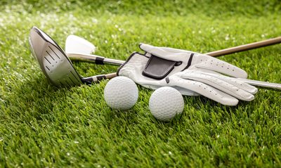 Golf clubs, balls, and glove on the fairway at Thousand Hills Golf Course next to Thousand Hills Resort Hotel