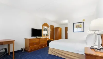 Renovated guest room with dresser and TV at Thousand Hills Resort Hotel in Branson